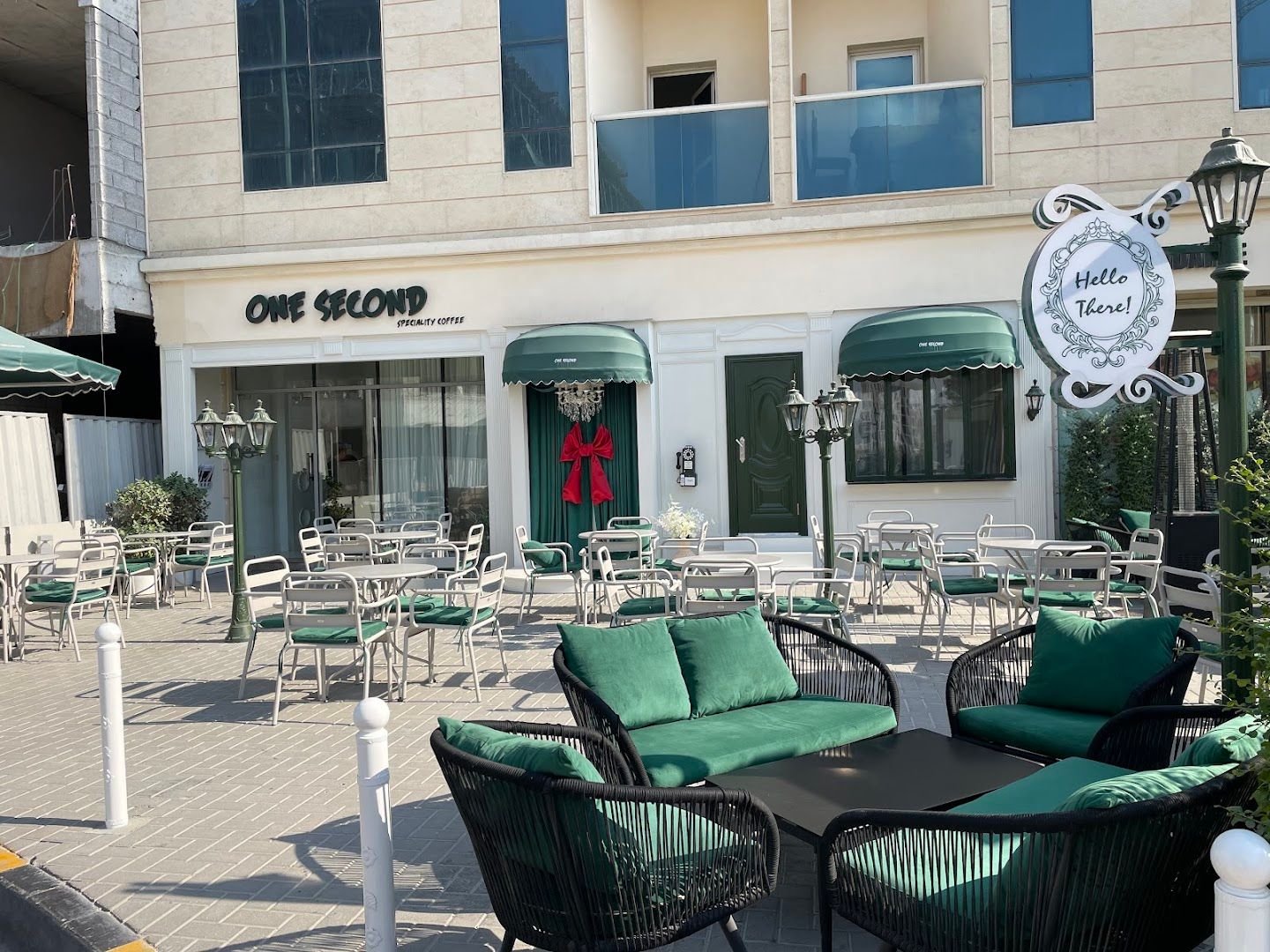 One Second speciality coffee storefront with green outdoor seating